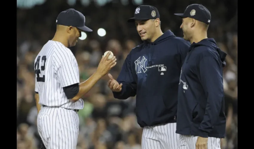 Andy Pettitte (c.) retiró del montículo a Mariano Rivera en el último partido de su carrera.